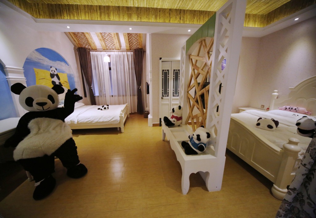 This picture taken on February 22, 2013 shows an employee wearing a panda suit introducing the rooms in a panda-themed hotel at the foot of Emei Mountain in Emeishan, southwest China's Sichuan province. The hotel is reportedly the first panda-themed hotel in the world. CHINA OUT AFP PHOTO (Photo credit should read STR/AFP/Getty Images)